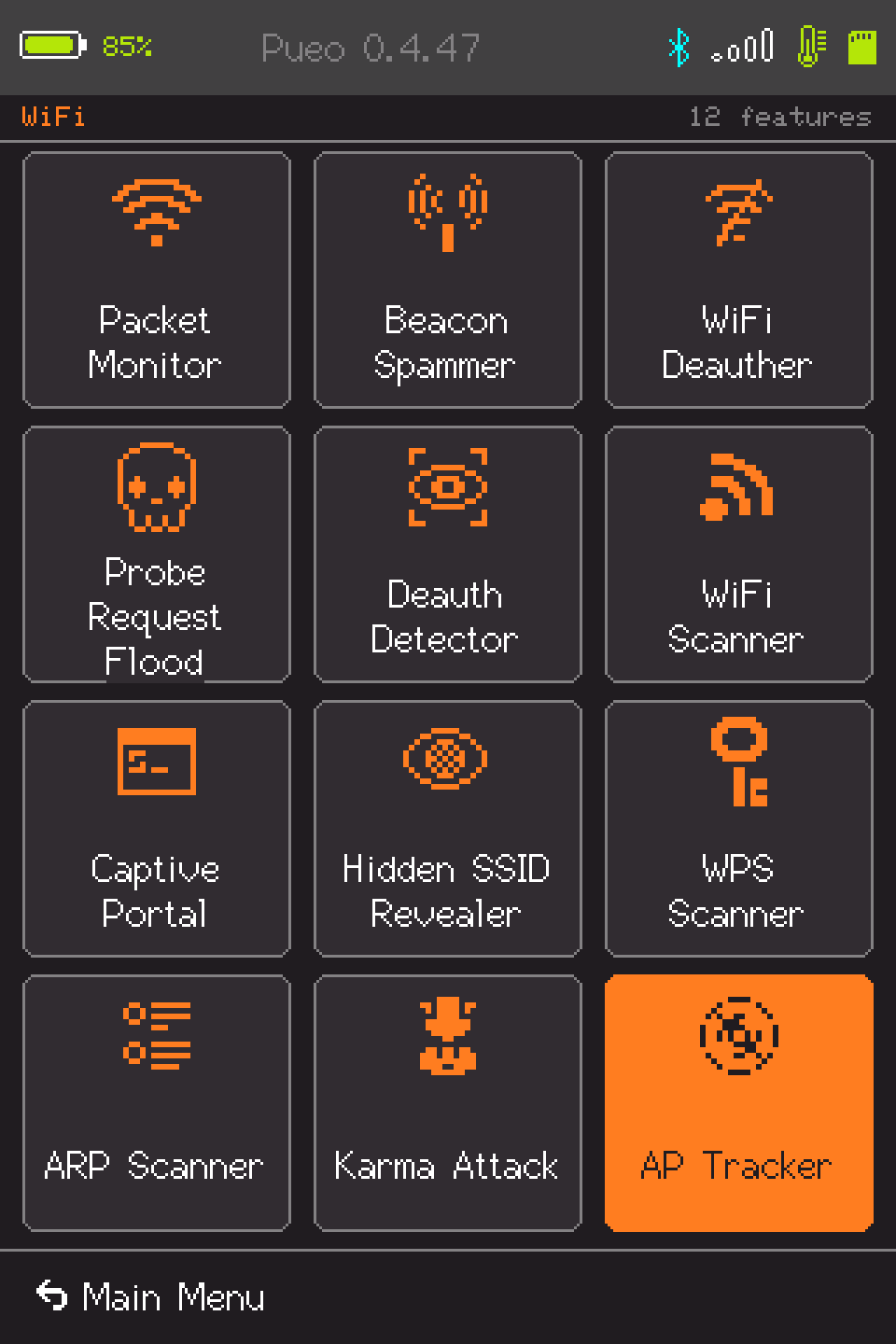 The Pueo WiFi submenu: twelve tiles in three columns - Packet Monitor, Beacon Spammer, WiFi Deauther, Probe Request Flood, Deauth Detector, WiFi Scanner, Captive Portal, Hidden SSID Revealer, WPS Scanner, ARP Scanner, Karma Attack and AP Tracker - each an icon above its name, with AP Tracker filled orange. A header reads WiFi on the left and 12 features on the right, and a Main Menu bar runs along the bottom. There is no page button: all twelve are on one screen. Probe Request Flood is wrapped onto three lines, the only label in the firmware that needs more than two.